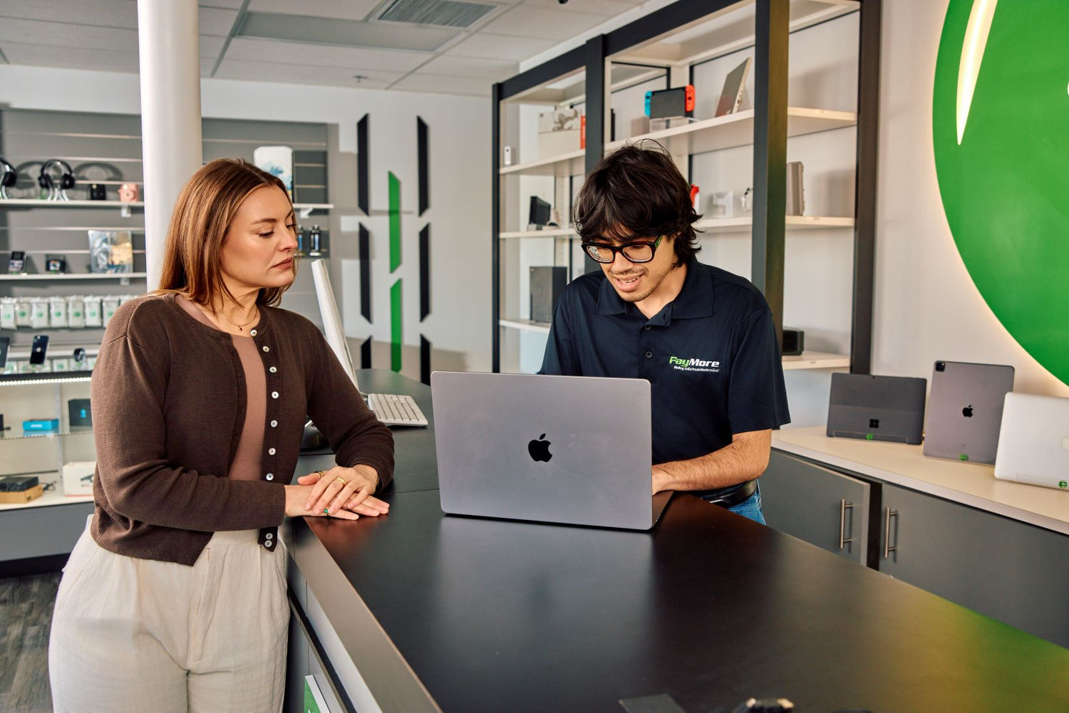 employee inspecting a laptop